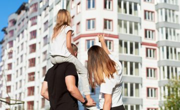 Sporty,Family,Of,Three,Are,Standing,With,Their,Back,To